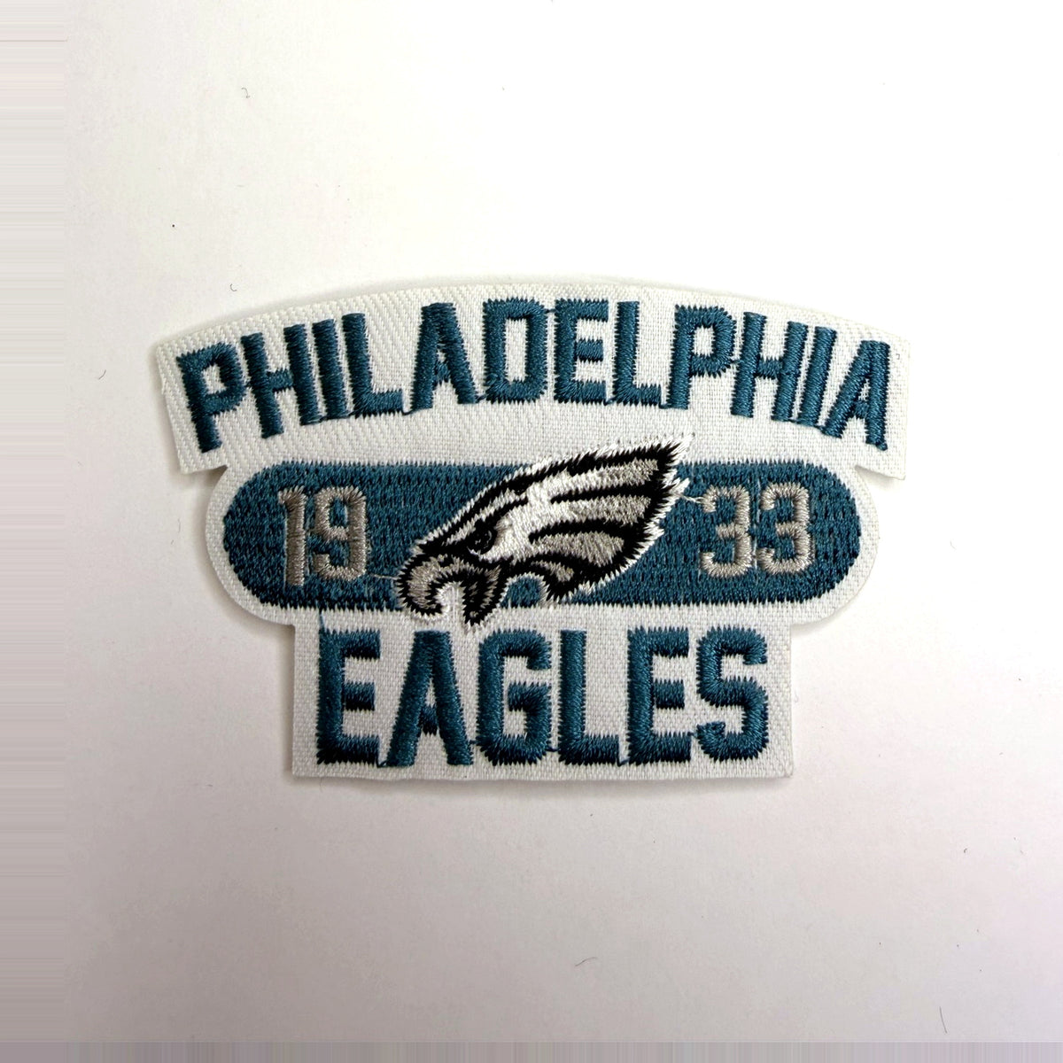 White and teal arch patch with eagle head